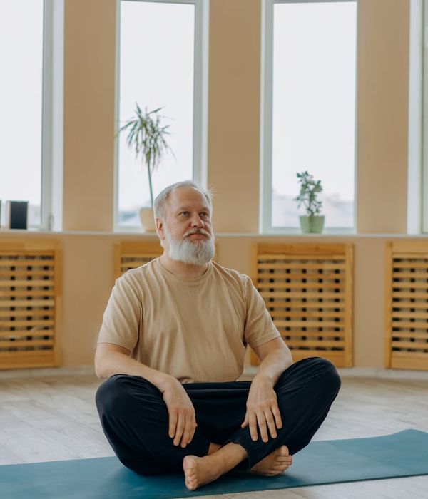 Man in a calm, focused pose performing a bodyweight exercise.